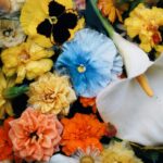 Colorful pansies, lilies, and marigolds beautifully arranged for a vibrant floral display.